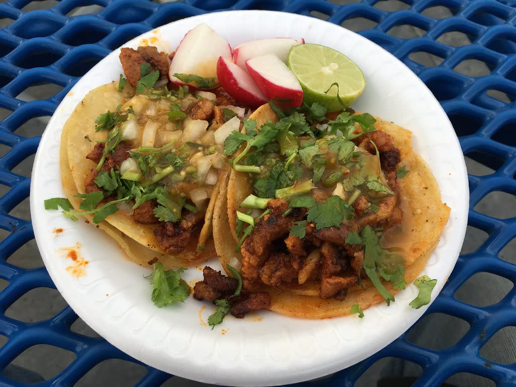 Fresh street tacos topped with coriander, onion and lime